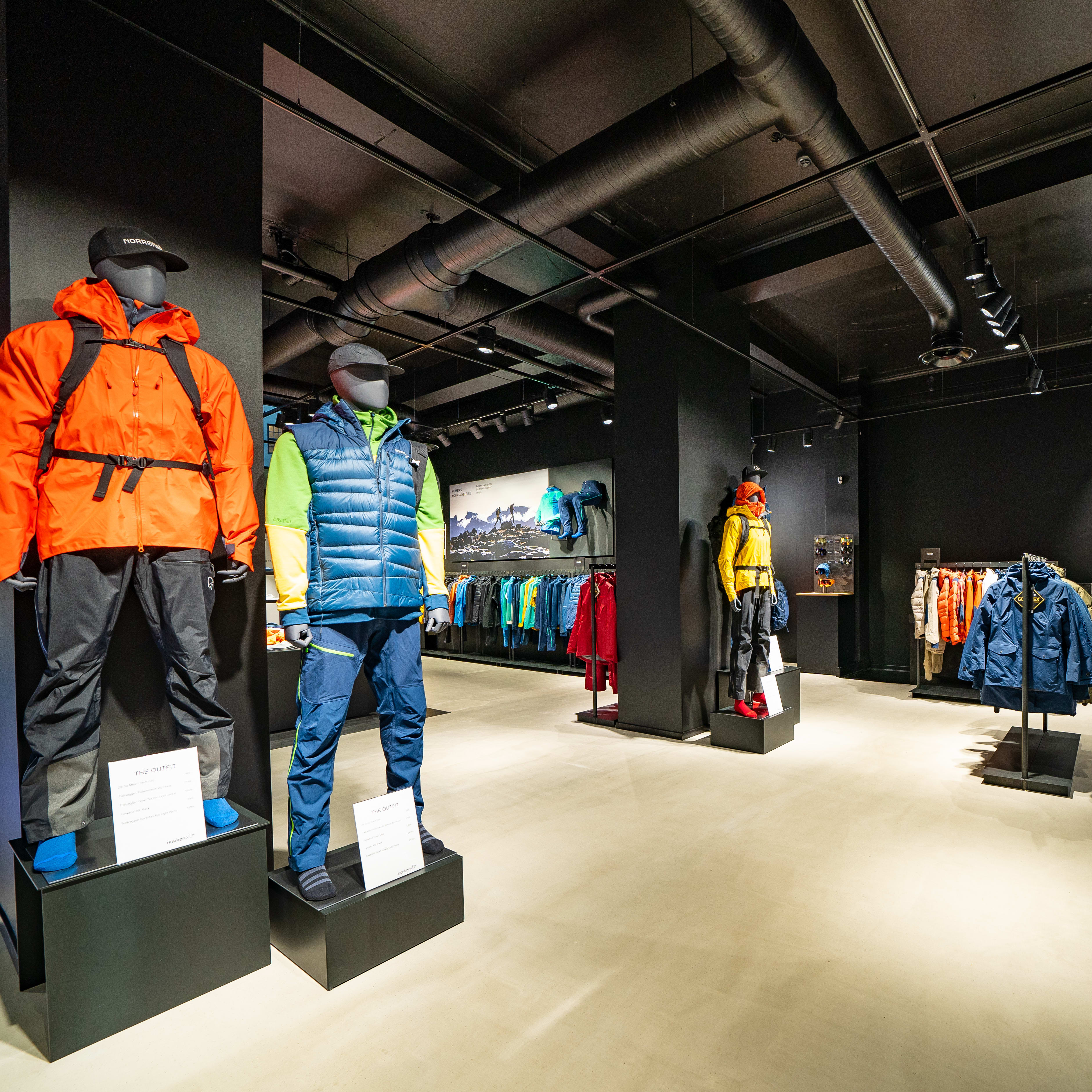 Norrøna retail store interior featuring mannequins dressed in colorful outdoor clothing.