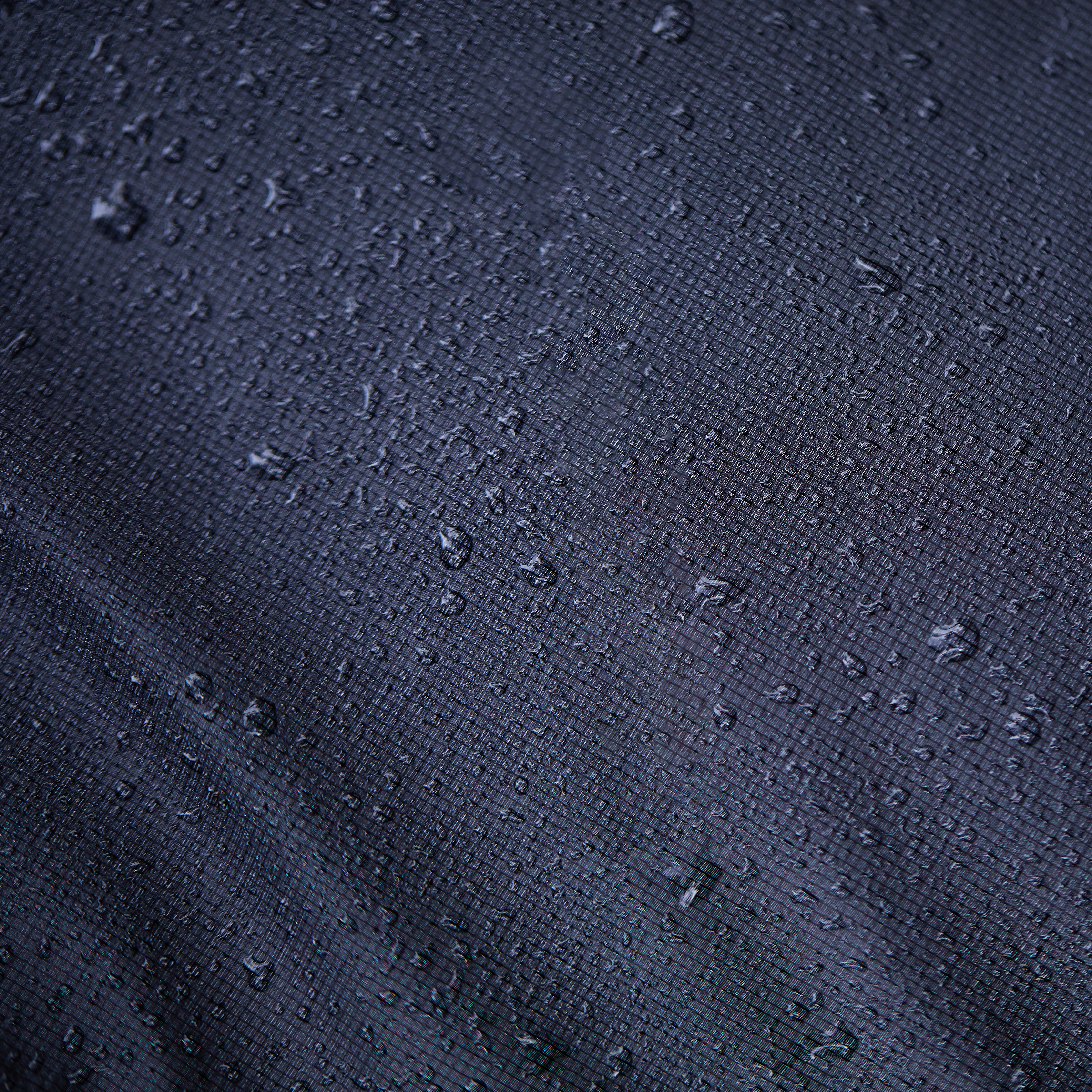 Close-up of a Norrøna fabric, with many water droplets on its surface.
