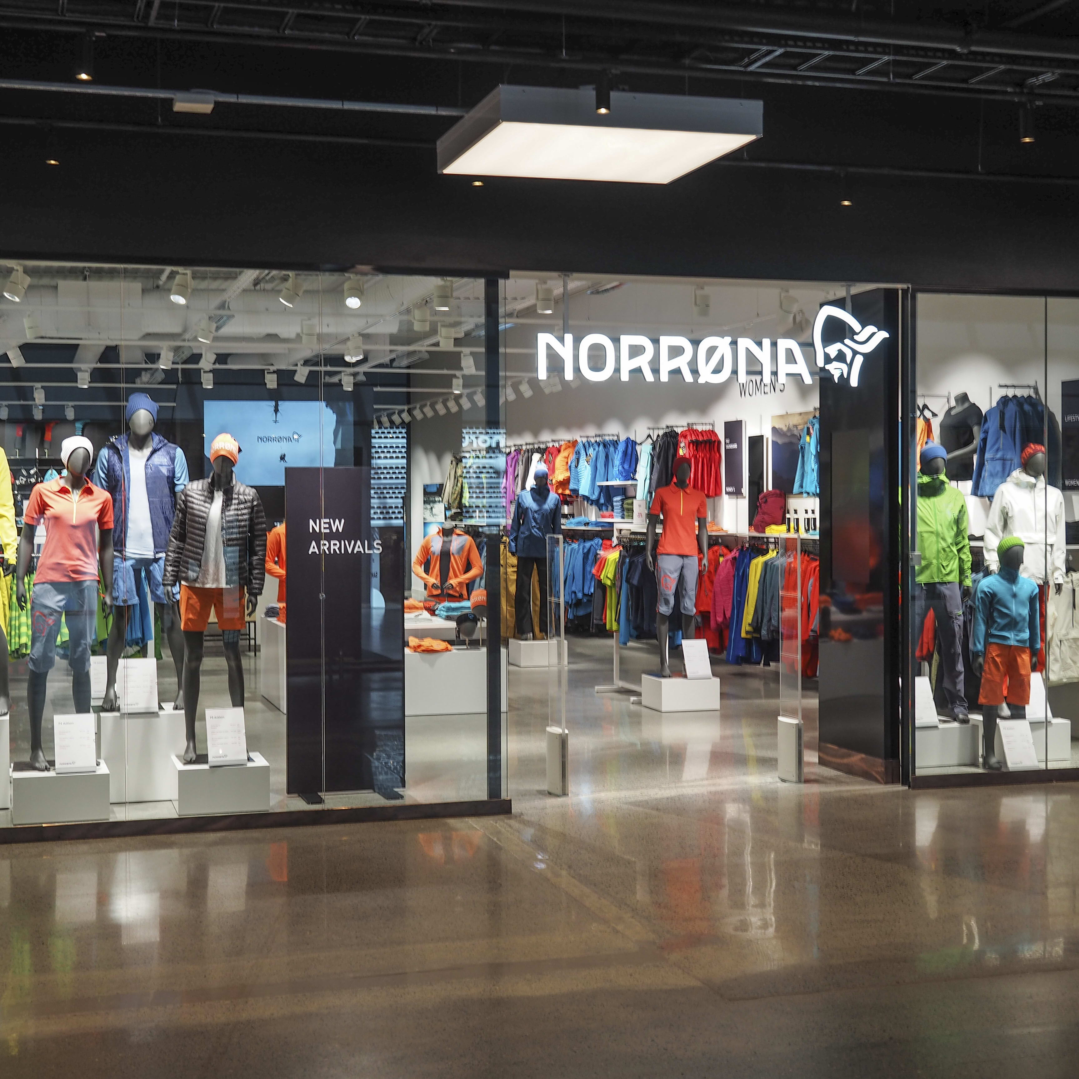 Storefront of a Norrøna clothing store with mannequins displaying new arrivals.