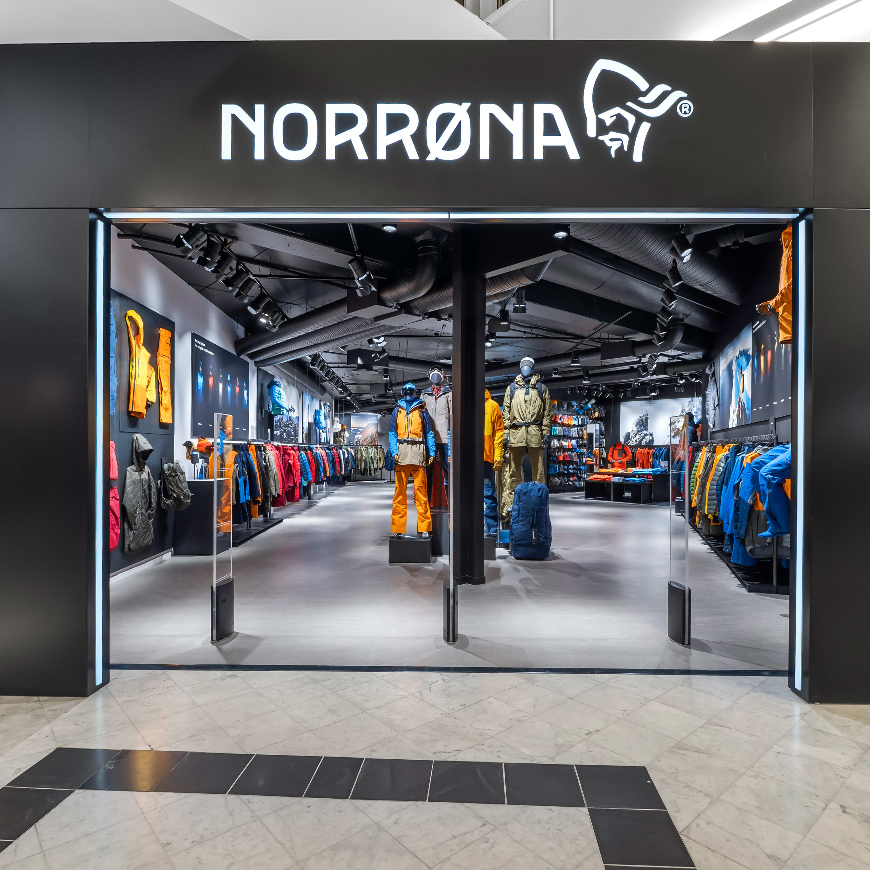 Norrøna store storefront with mannequins wearing Norrøna clothing.  
