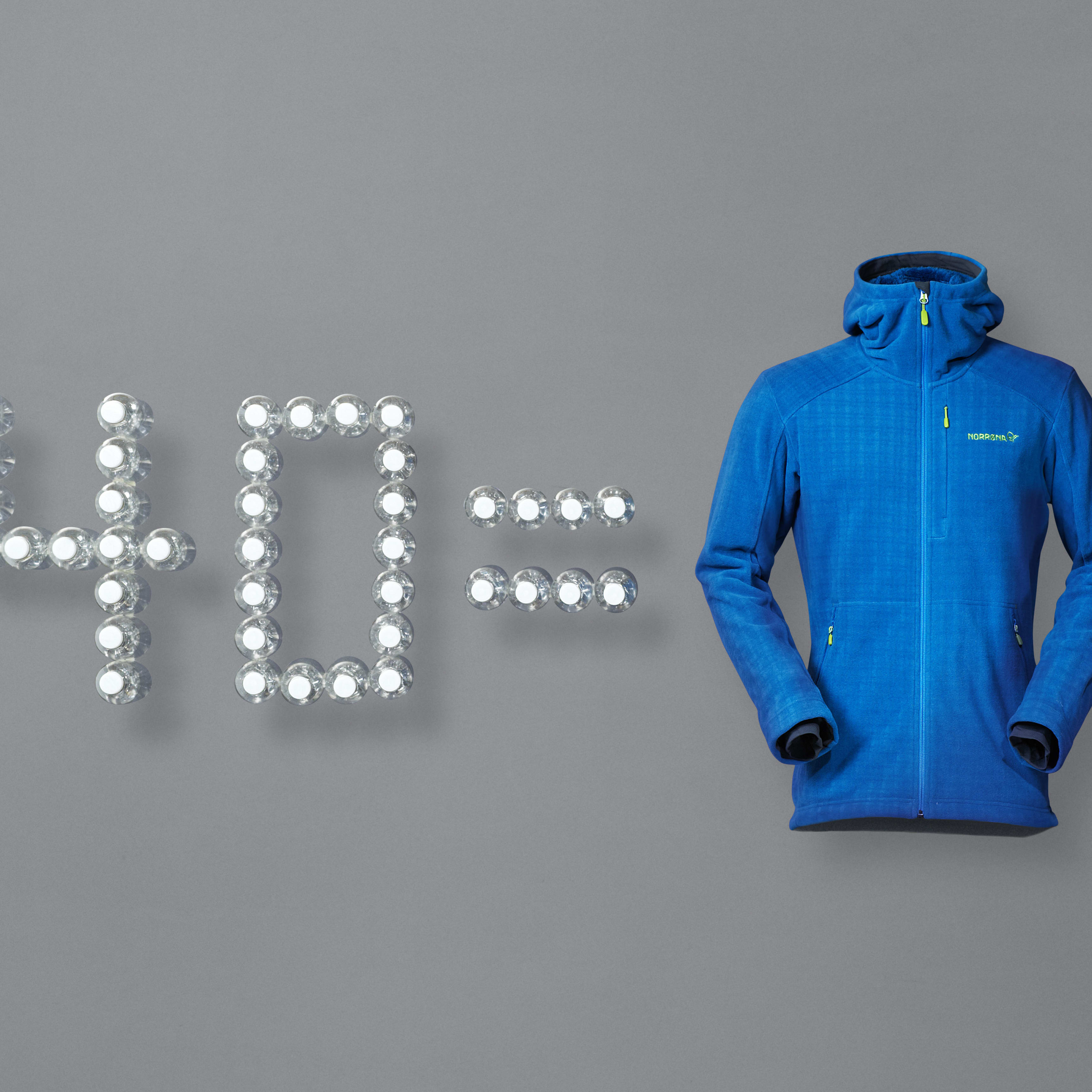"40 =" spelled with lit bulbs next to a blue Norrøna fleece hooded jacket, on grey background.