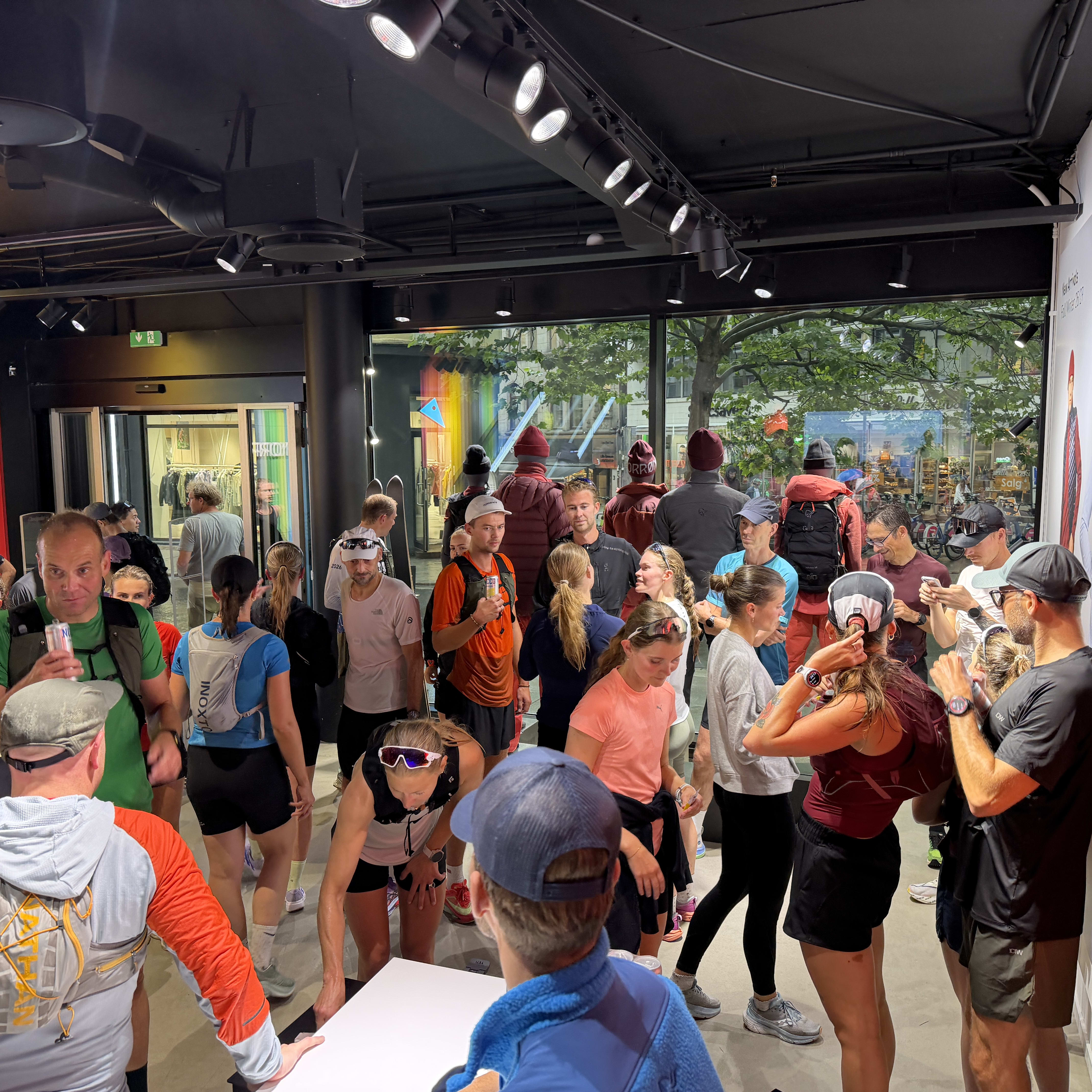 A crowd of people wearing Norrøna apparel inside a retail store.