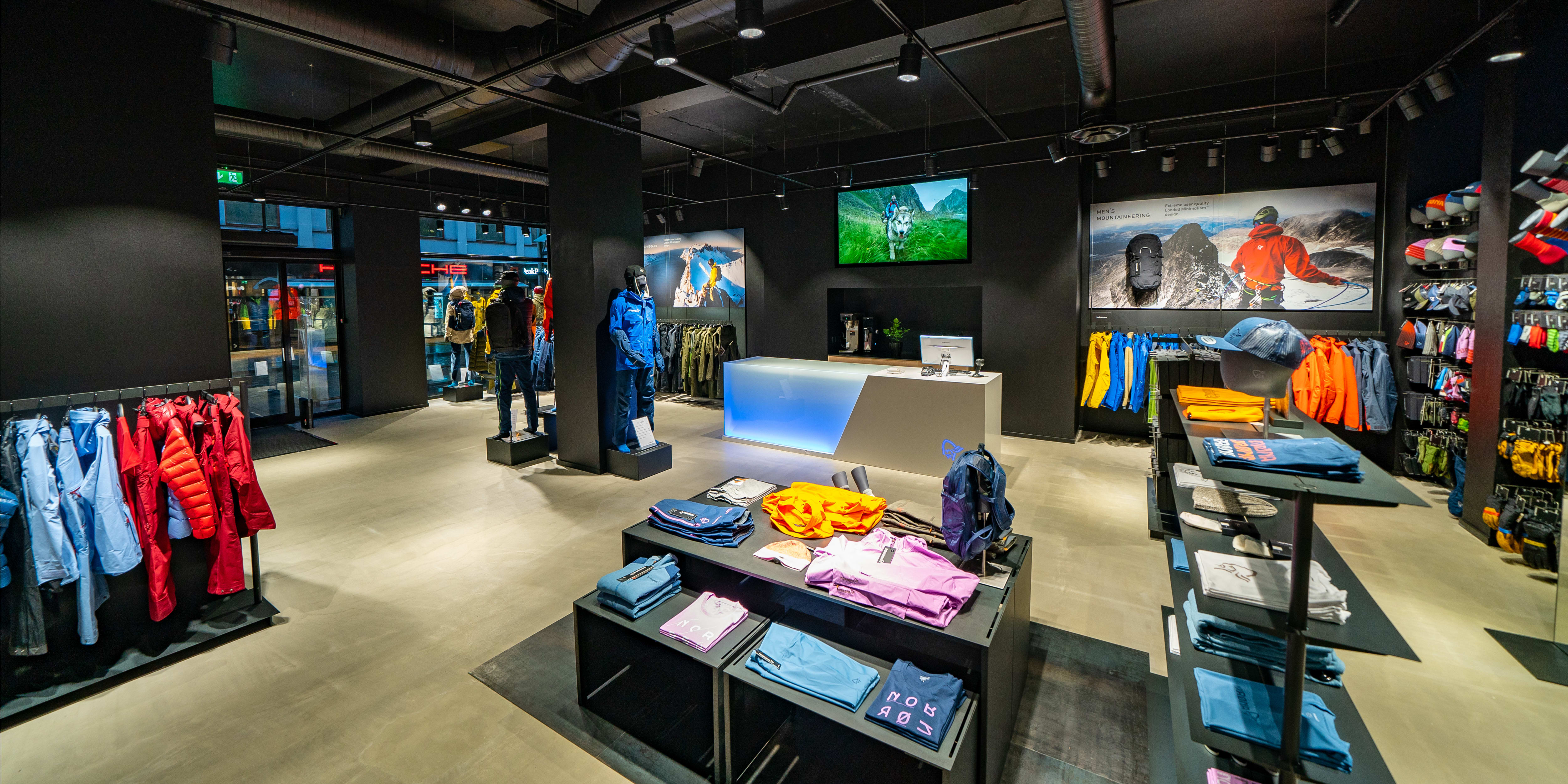 Norrøna retail store interior displaying Norrøna clothing, mannequins, and outdoor gear.