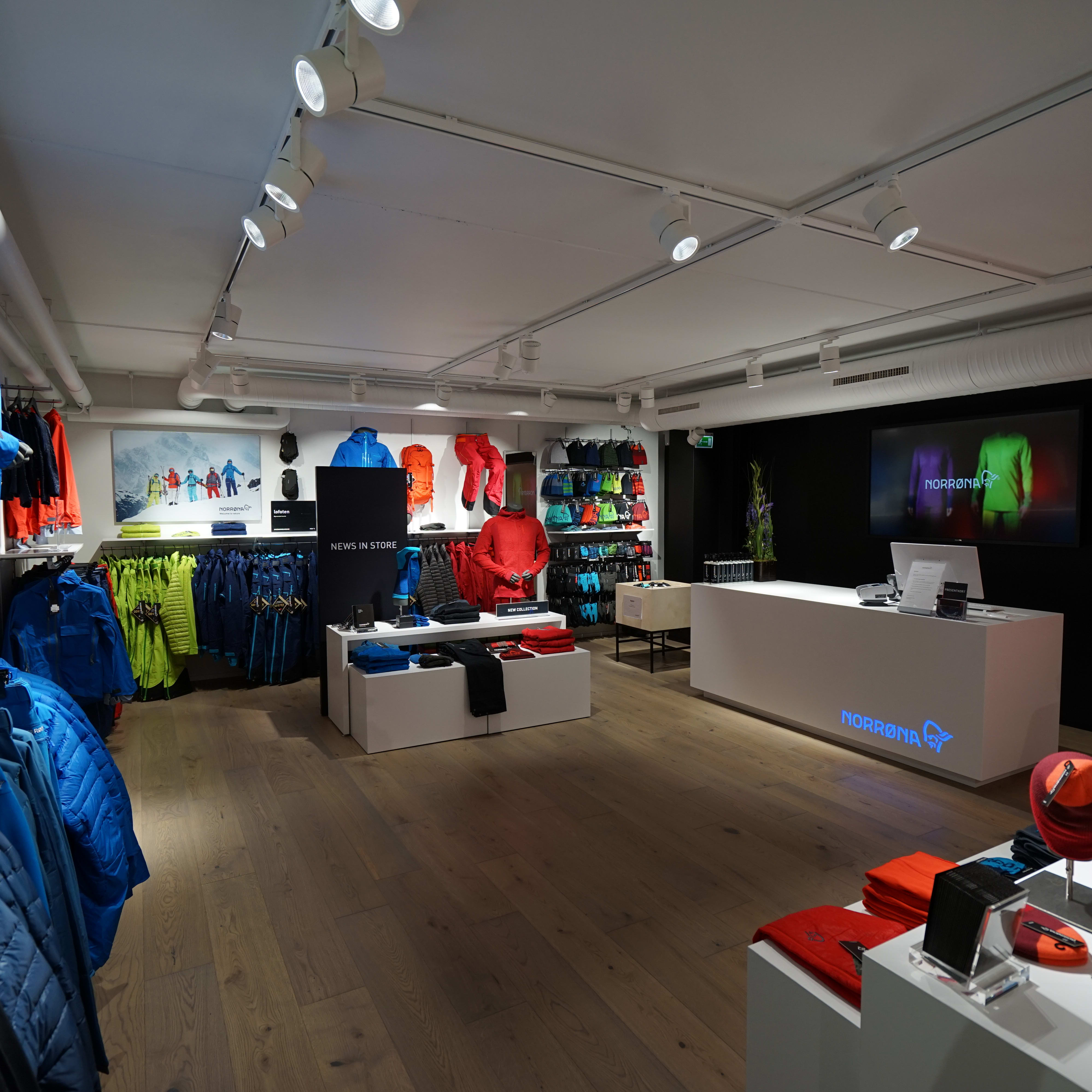 Interior of a Norrøna store showcasing colorful Norrøna outdoor clothing on display.