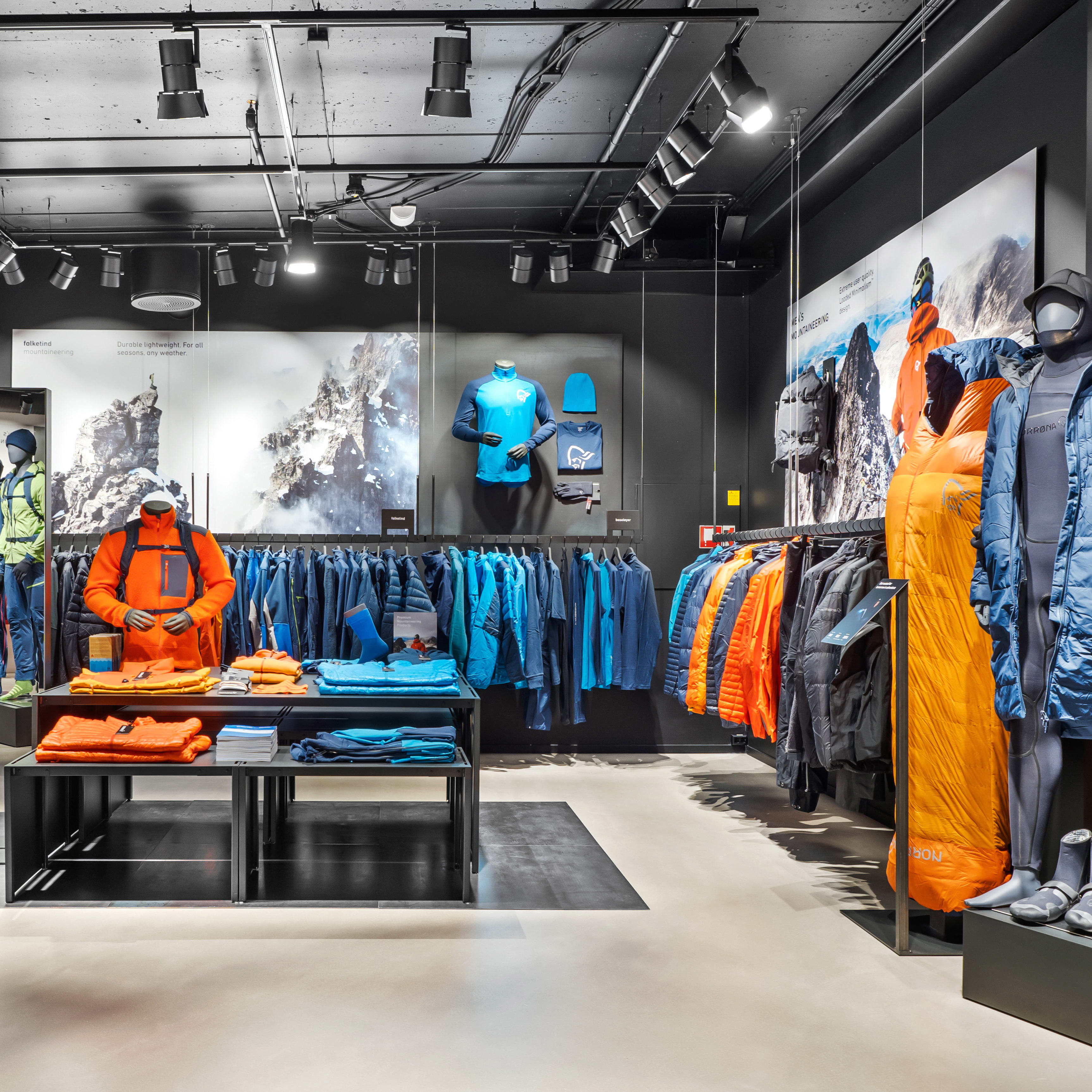 Interior of a Norrøna retail store showcasing outdoor clothing and gear on mannequins and racks.
