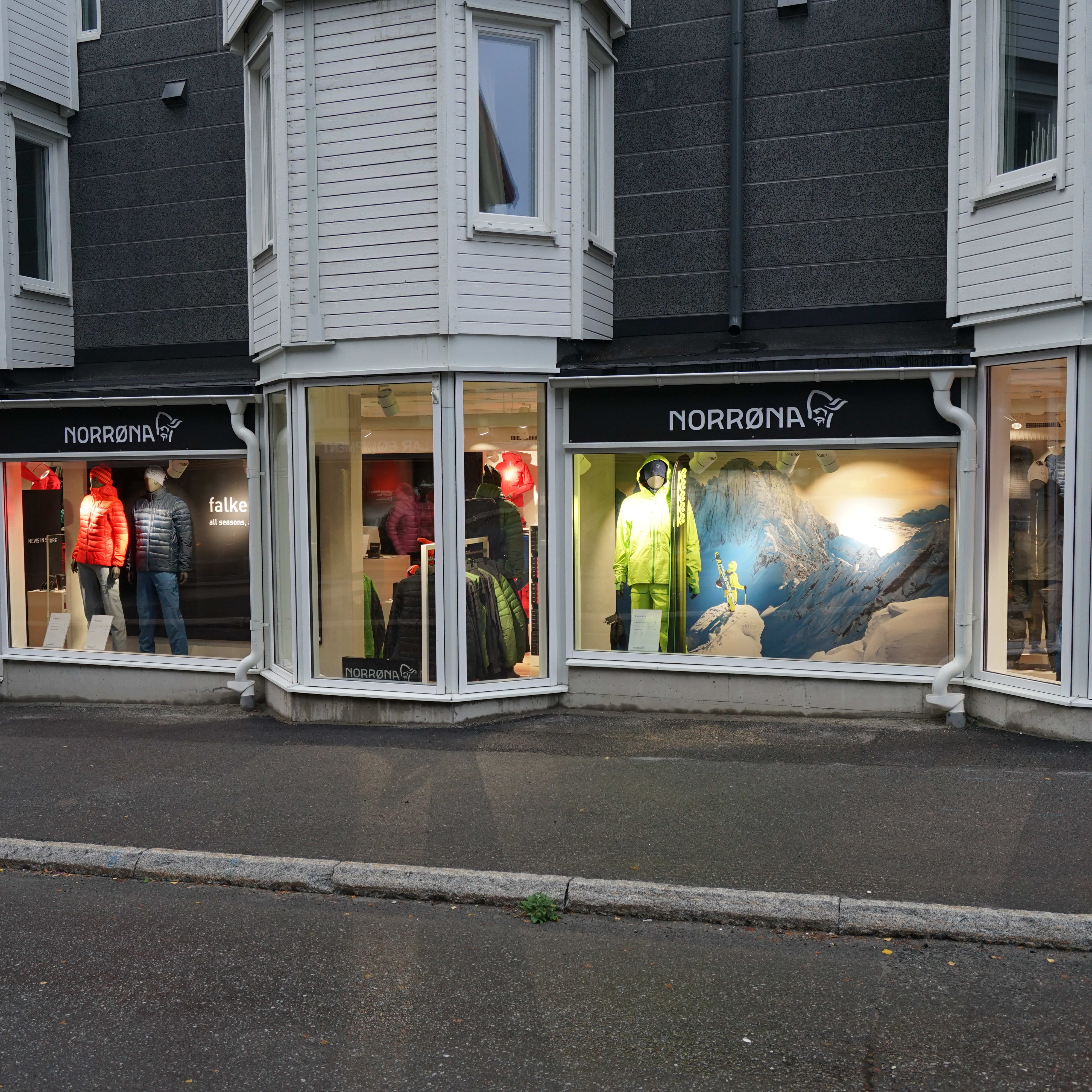 A storefront with a Norrøna logo and mannequins wearing Norrøna clothing.  
