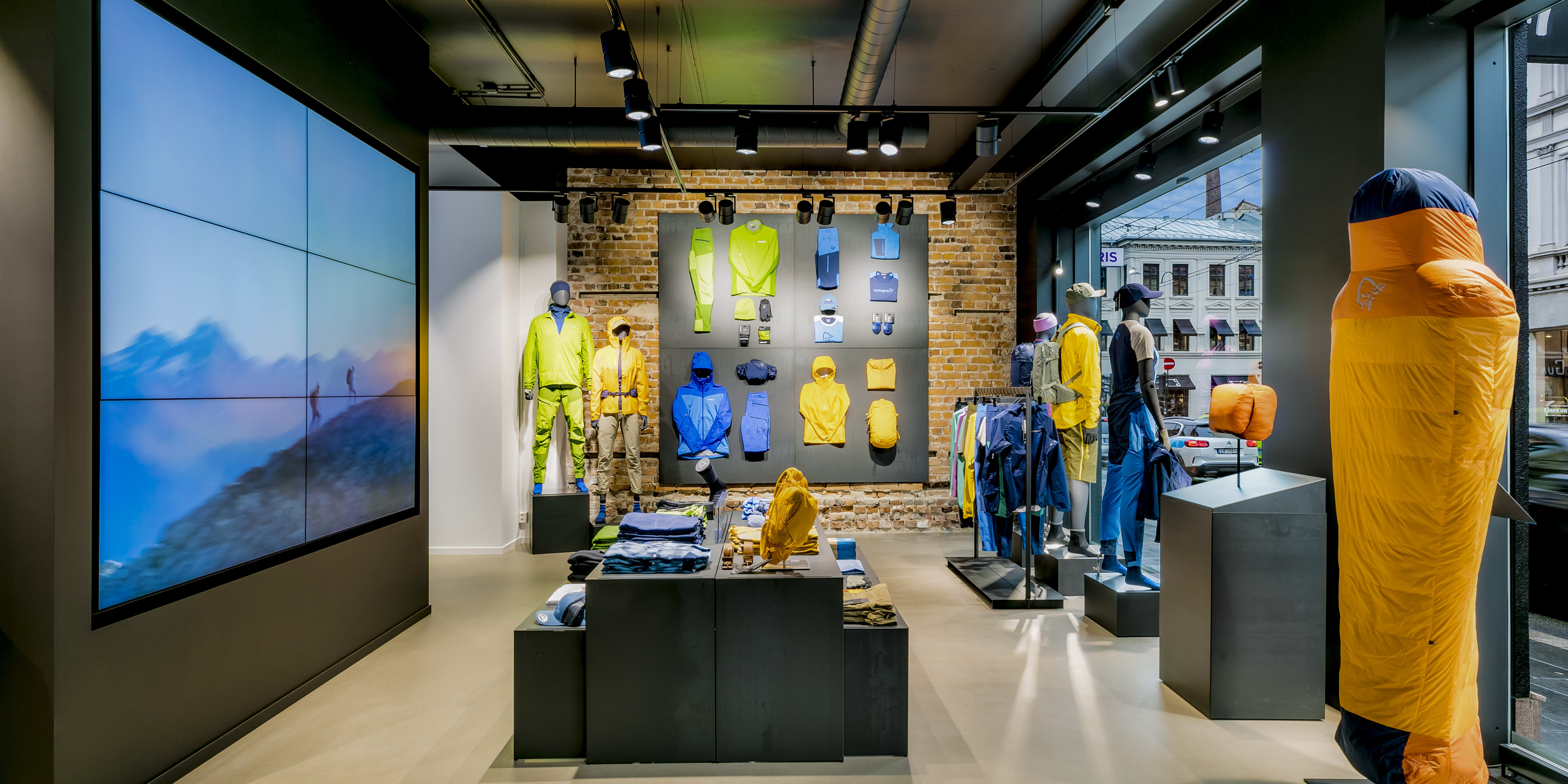 Norrøna retail store interior showcasing colorful Norrøna clothing on mannequins and displays.
