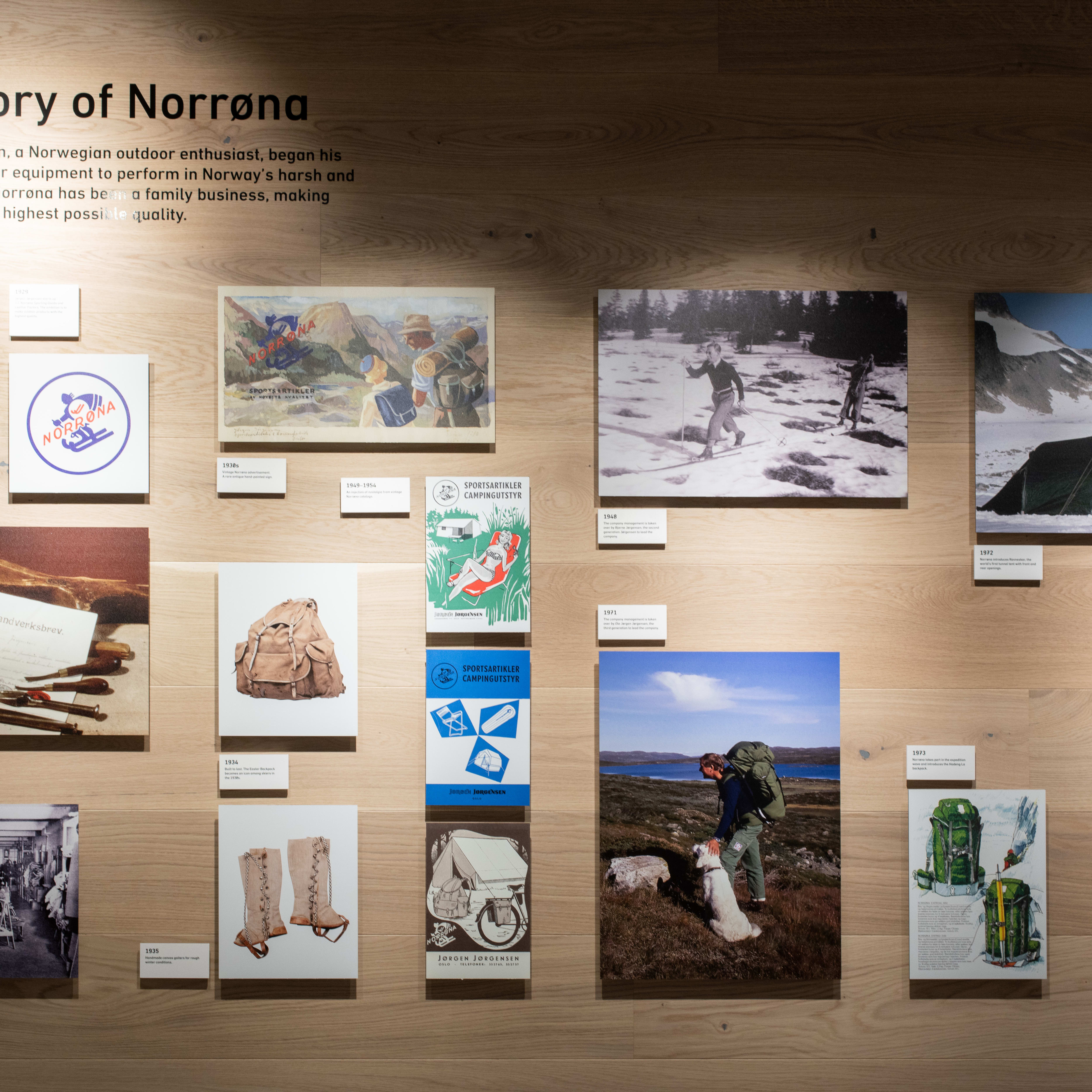 Display of vintage Norrøna products, including a backpack, clothing, and a tent.  The image depicts the history of Norrøna.  
