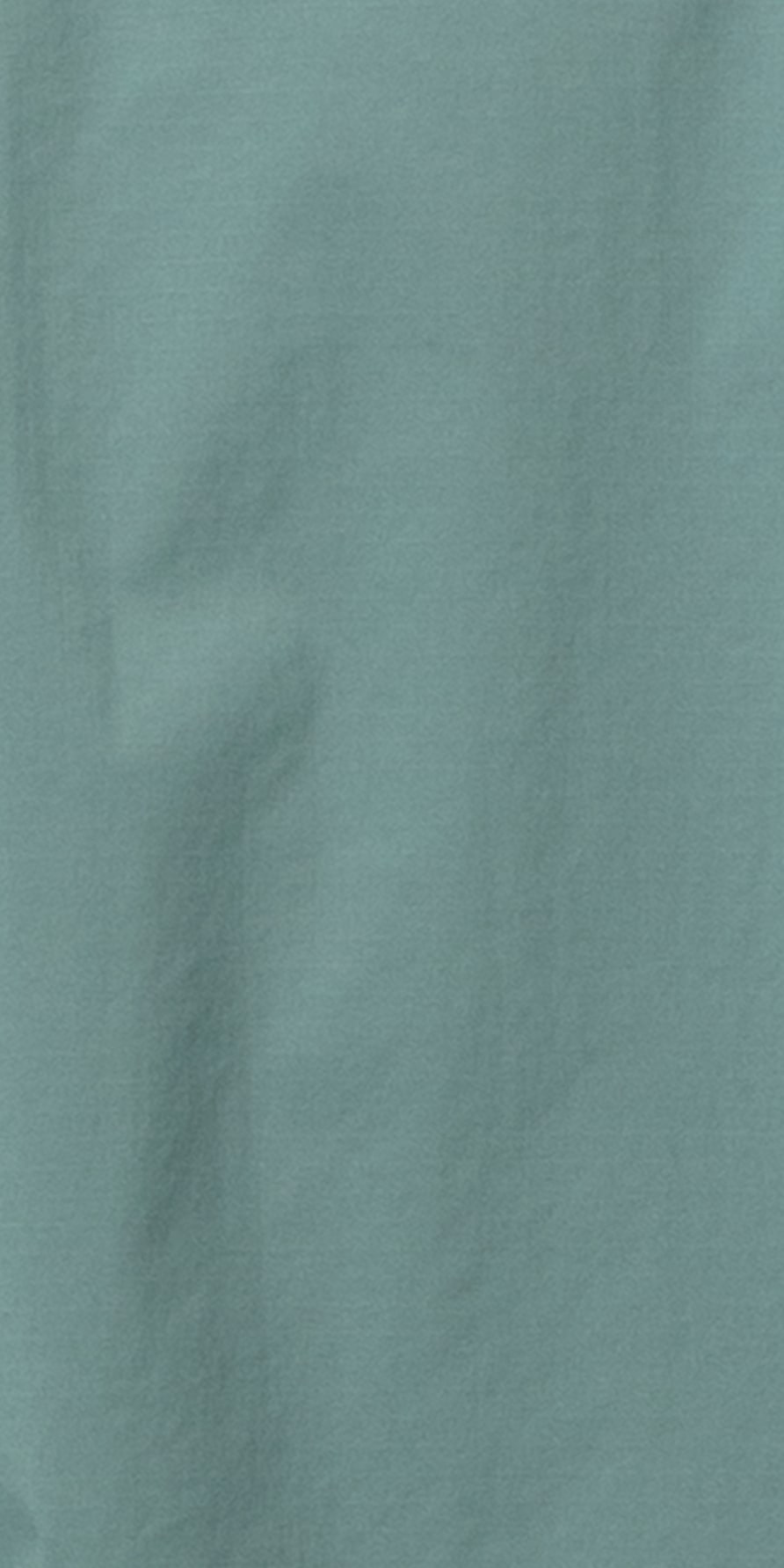 Close up of teal colored Norrøna fabric with wrinkles. 
