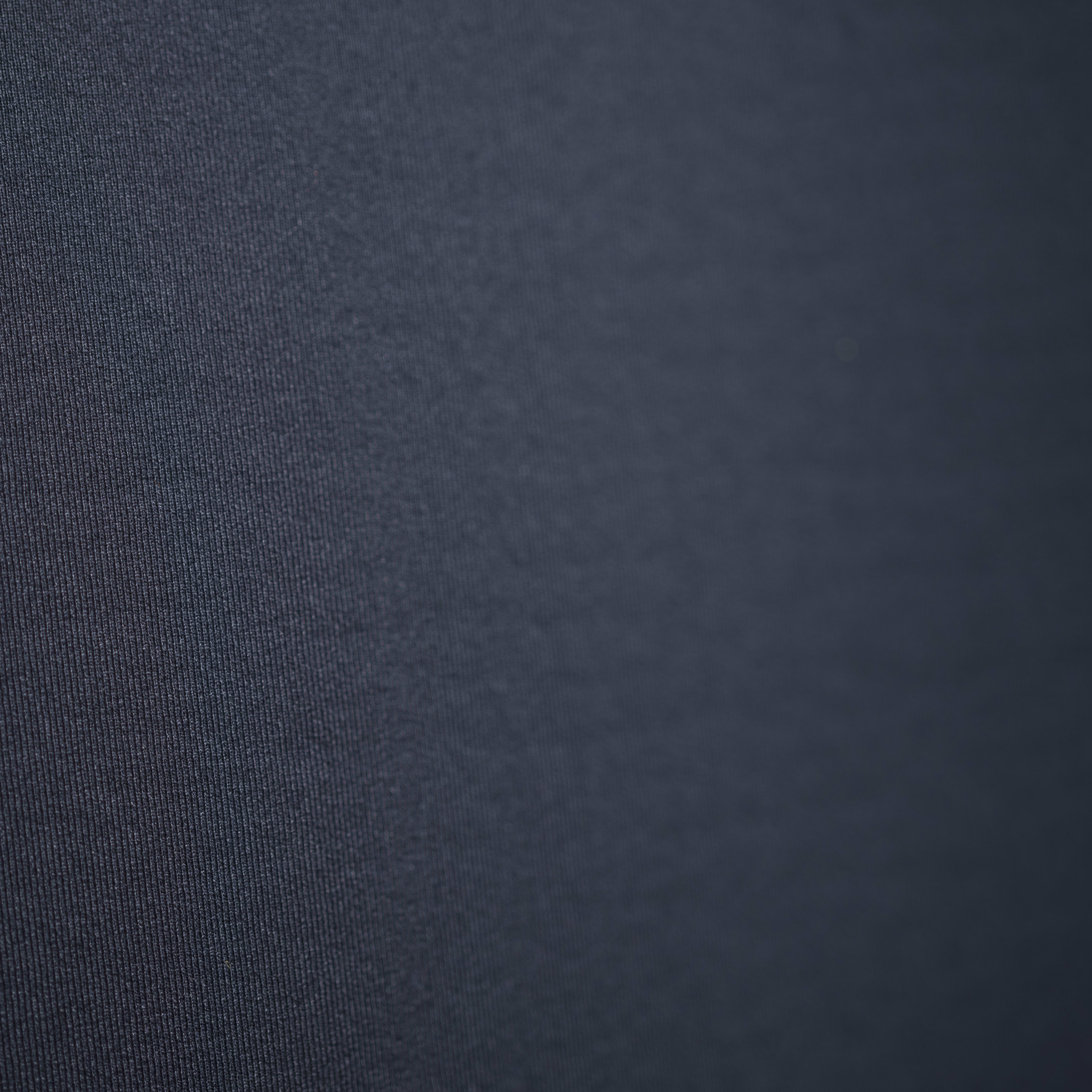 Close up of a dark blue Norrøna fabric with a textured pattern. 
