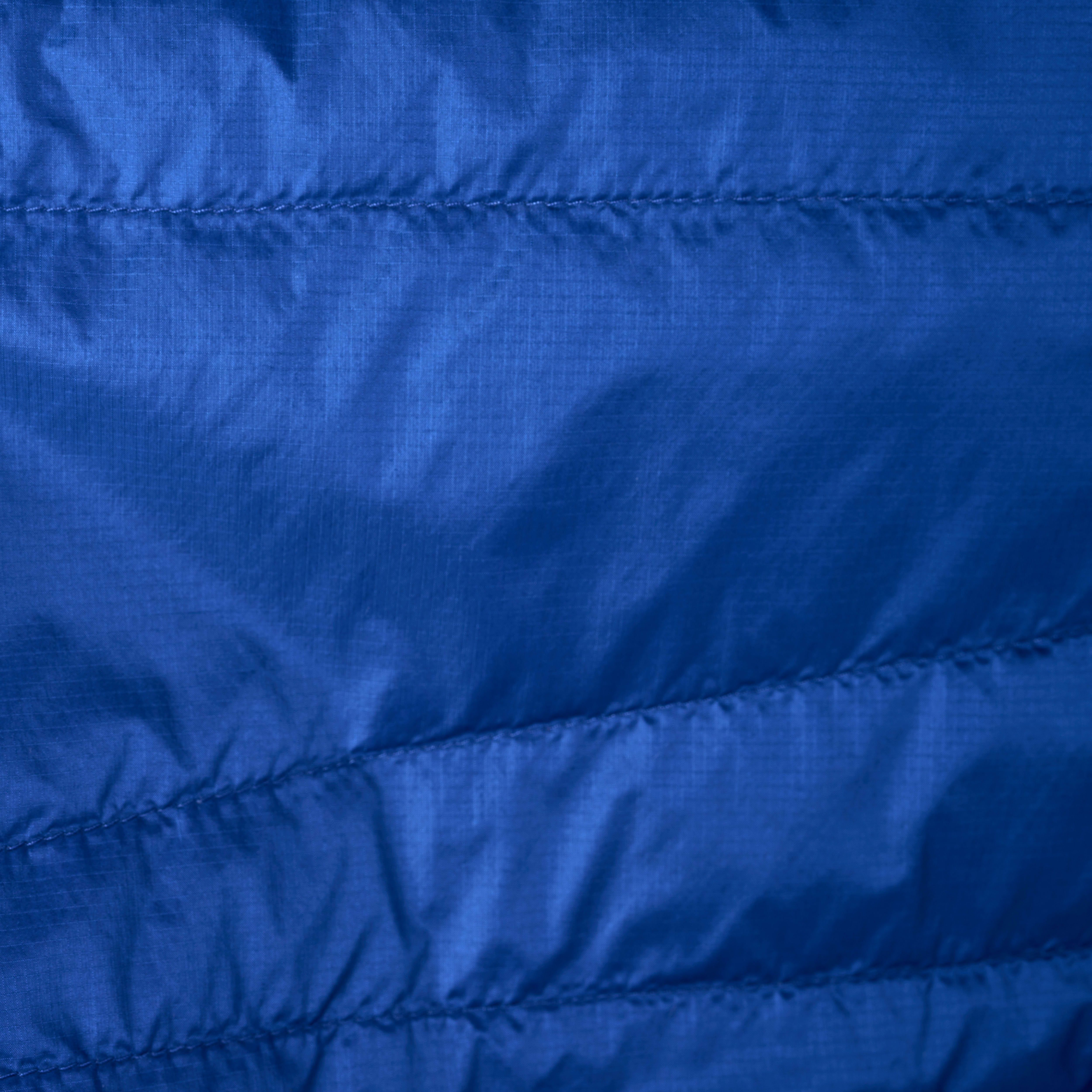Close-up of blue Norrøna jacket fabric with horizontal stitching.