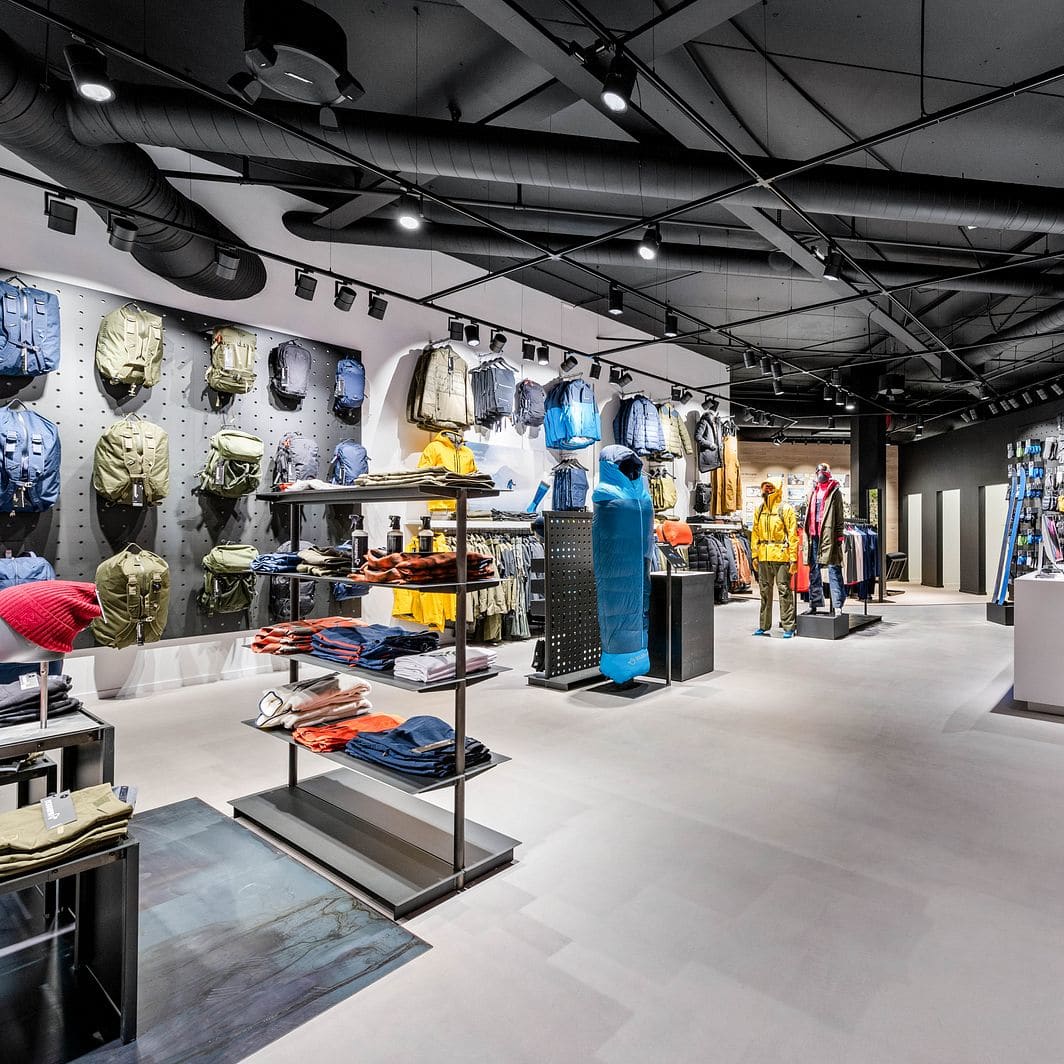 Modern retail store displaying Norrøna clothing, backpacks, and outdoor gear.