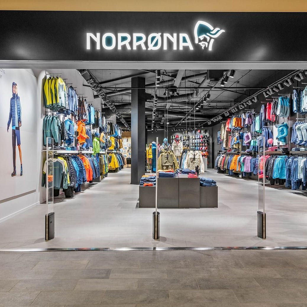 A Norrøna store with a variety of clothing displayed on racks, mannequins, and shelves.  
