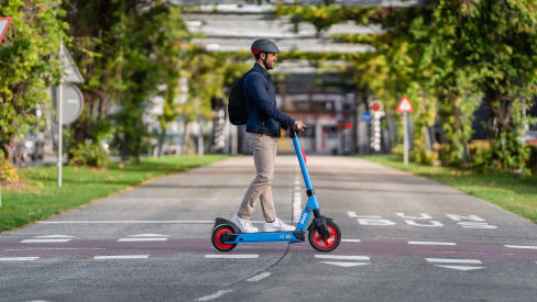 Person riding Dott electric scooters