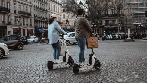 People riding electric scooters on the streets of Paris