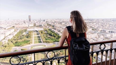 Tourist looking at Paris from atop the Eiffel Tower