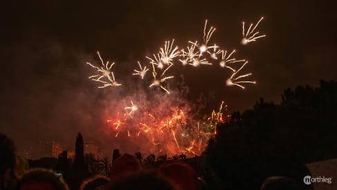 People watching a castillo de fuegos artificiales in Valencia.