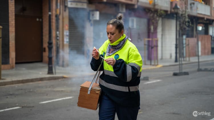 Woman with firecrackers in a box during Despertá in Valencia during Fallas