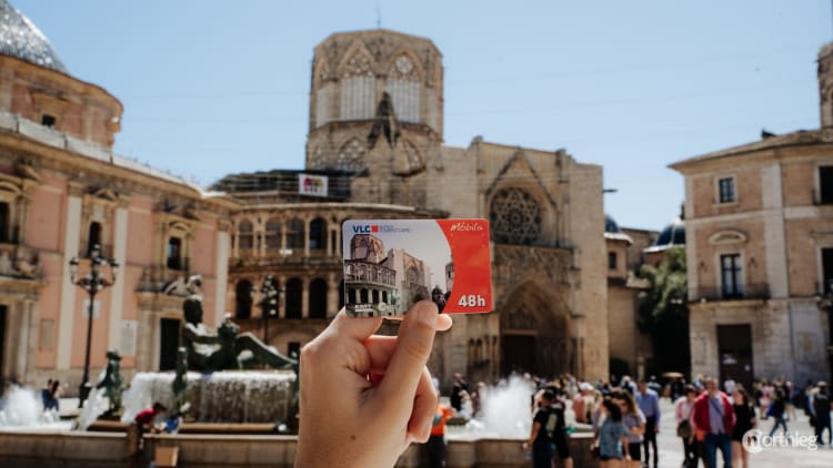 Valencia Tourist Card displayed near Valencia Cathedral, showcasing the convenient scanning process for tourist discounts.