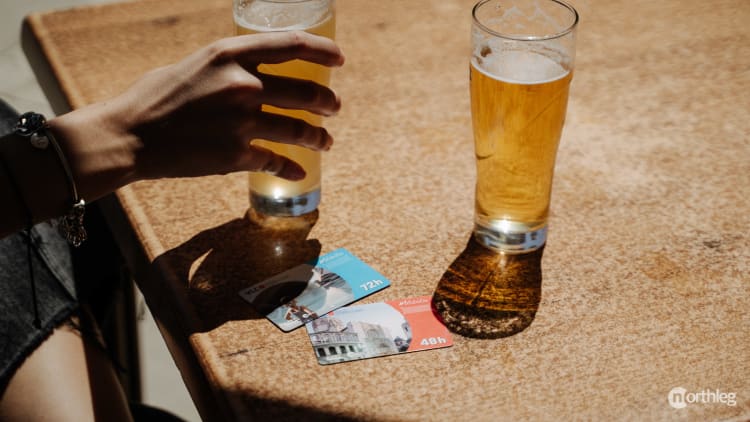 A tourist card being presented at a restaurant table, ready to receive a dining discount.