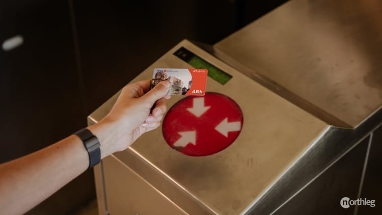 Close-up of a public transport validation machine for the Valencia Tourist Card with a card being tapped.