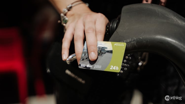 A tourist card for Valencia displayed next to a bicycle, representing city exploration options.