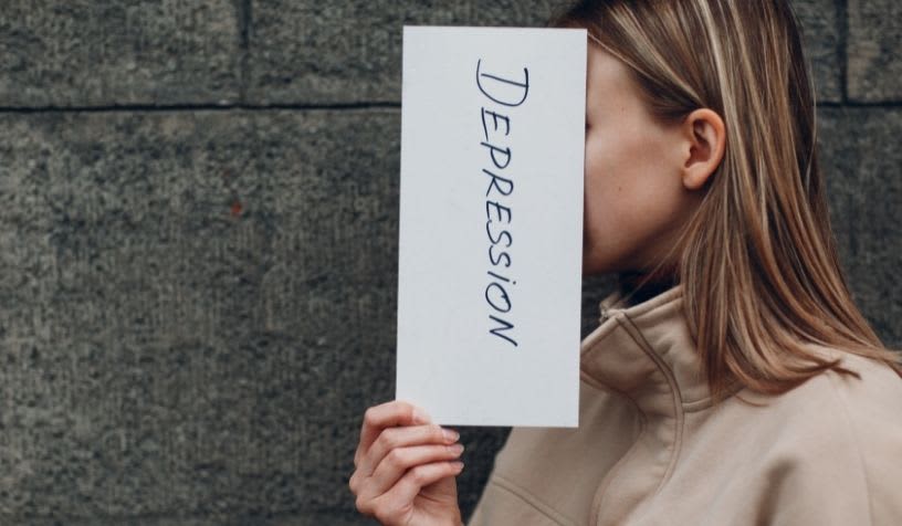 woman holding depression card