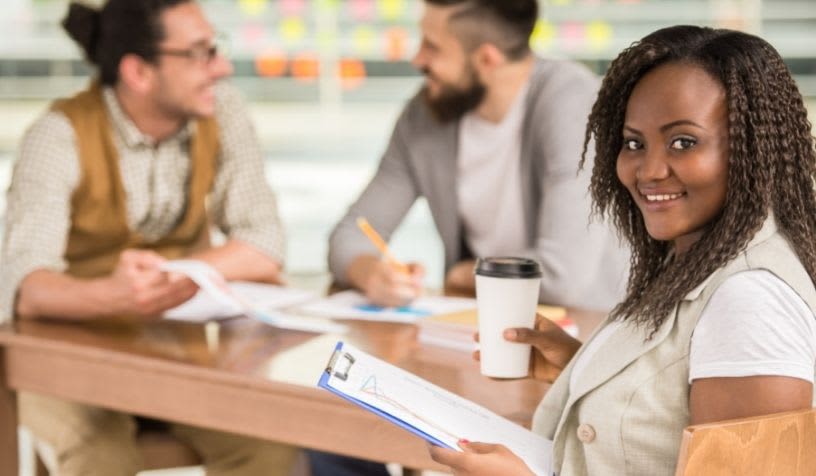 woman smiling with coworkers