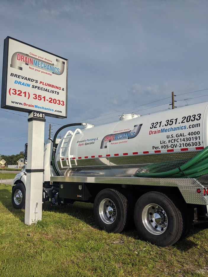 Drain Mechanics branded septic truck and business signage