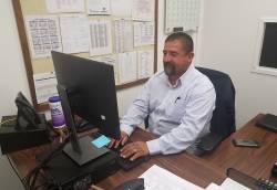 Carlos Garcia, park services coordinator for City of Bakersfield Recreation and Parks Department, in a rare moment at his desk. Photo courtesy of Dianne Hoover.