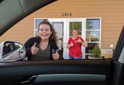 Celeste Rogers (left) and Randi Wyatt (right), of the Knapp Senior Center, providing drive-through meals to older adults during COVID-19. Photo courtesy of August Vandiver.