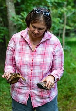 Bonnie Gray, environmental recreation specialist for Prince William County Dept. of Parks, Recreation & Tourism, holding two turtles. Photo courtesy of Dianne Wahl.