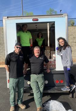 Joe Pruitt (front, center), natural and cultural resources section coordinator for Gwinnett County Parks and Recreation, with his staff and a truck with food for people impacted by COVID-19. Photo courtesy of Mark Patterson.