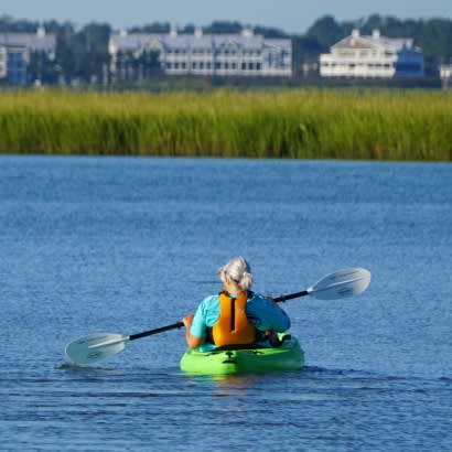 Person kayaking on waterfront