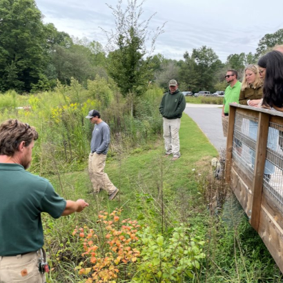 A group of staff and stakeholders review a green stormwater infrastructure project. 
