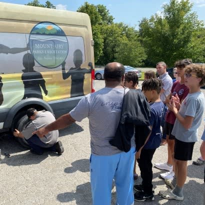 Students learn how to change a tire as part of the City of Mount Airy’s (North Carolina) youth workforce development program.