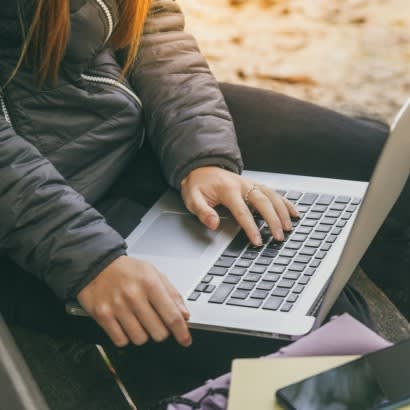 Person types on laptop