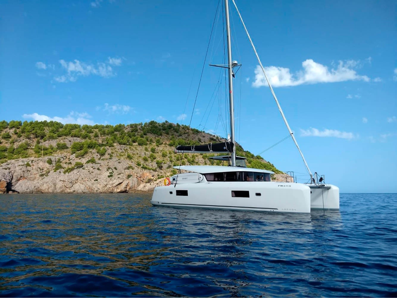 Genista II Lagoon 42 moored at Sant Antoni de Portmany Port