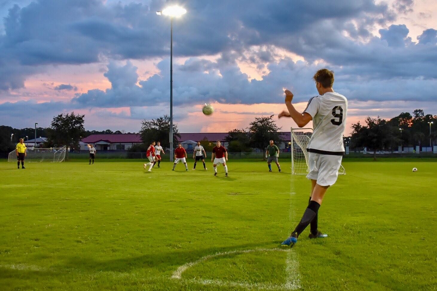 Night soccer match under floodlights