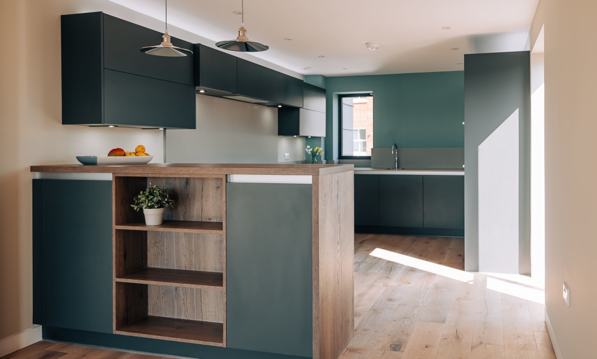 A modern kitchen in deep blue and wooden tones