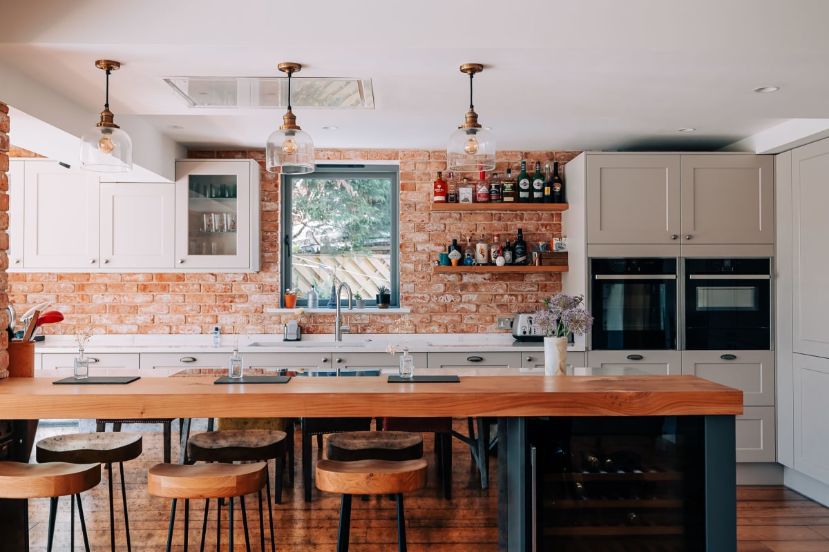 A Country Kitchen with dark blue and cream Shaker furniture and wooden worktops