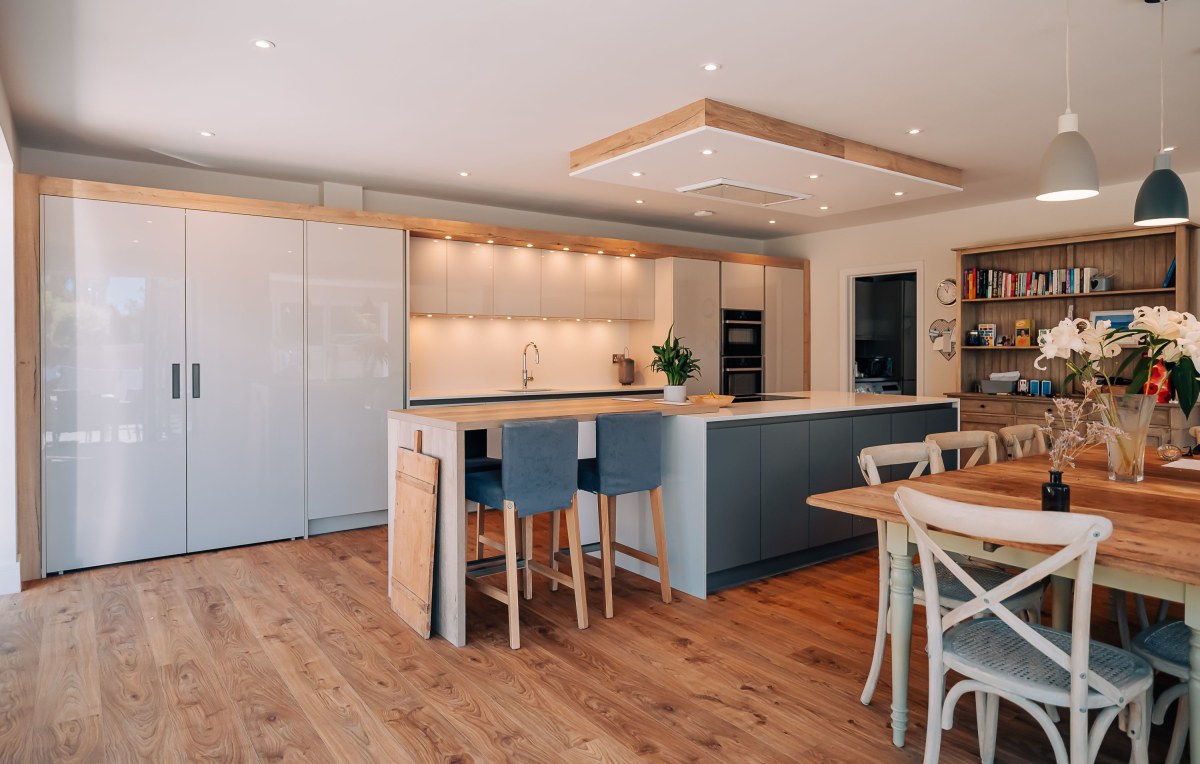 A wooden Floor, modern kitchen with blue units in the kitchen island