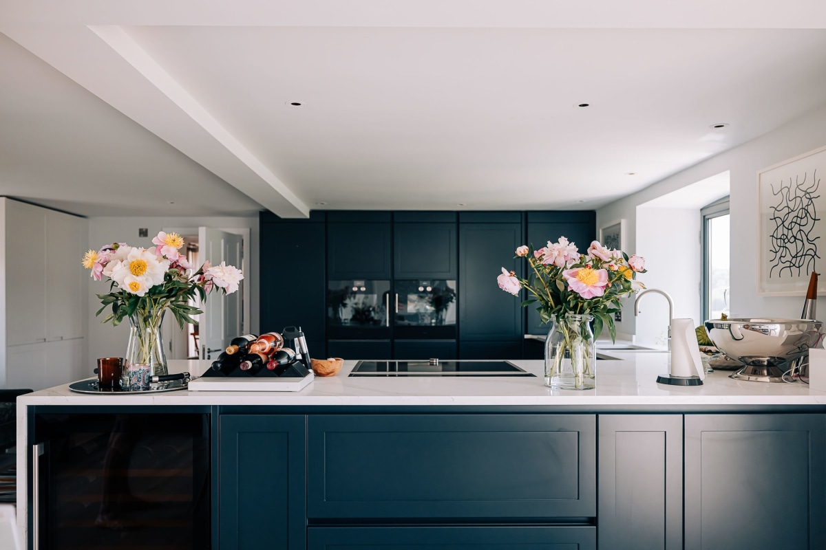 A Contemporary Kitchen in the South Downs with Farrow and Ball Railings cupboards and white quartz worktops