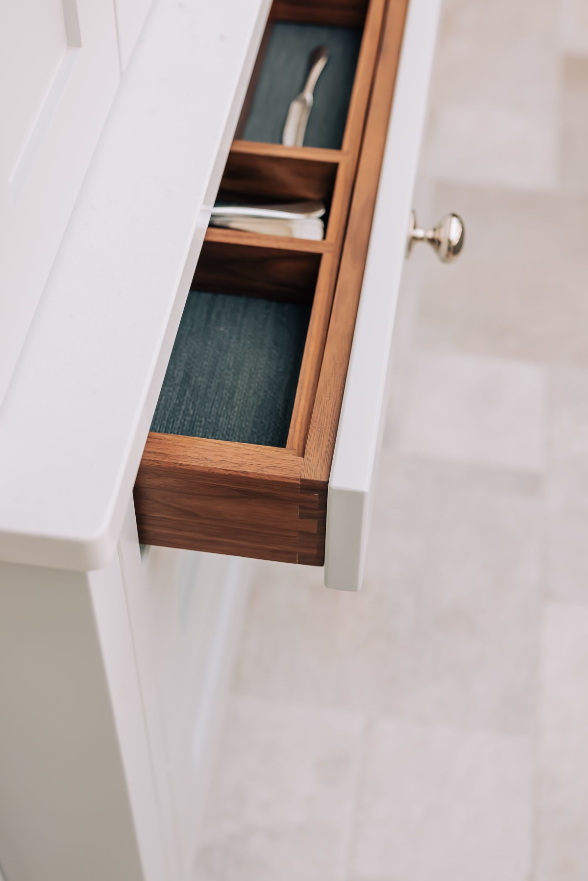 A kitchen drawer with walnut interior