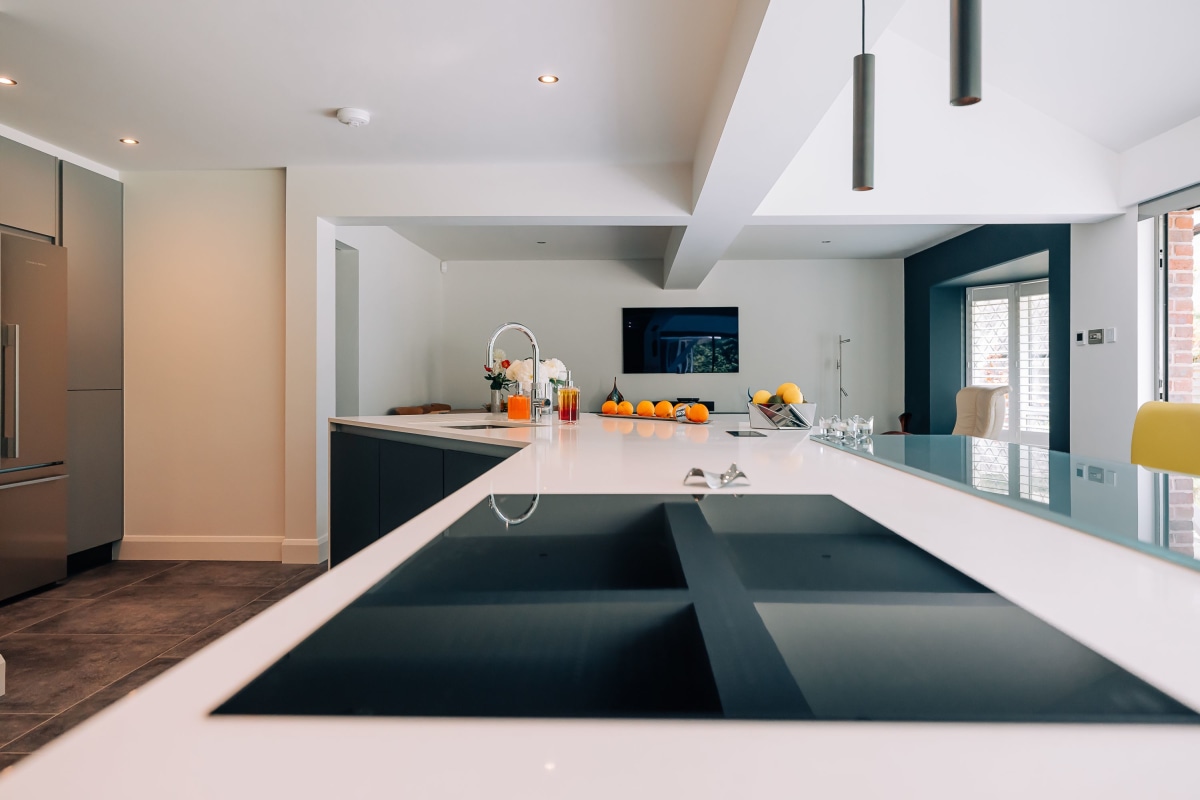 An induction hob set into white quartz worktops