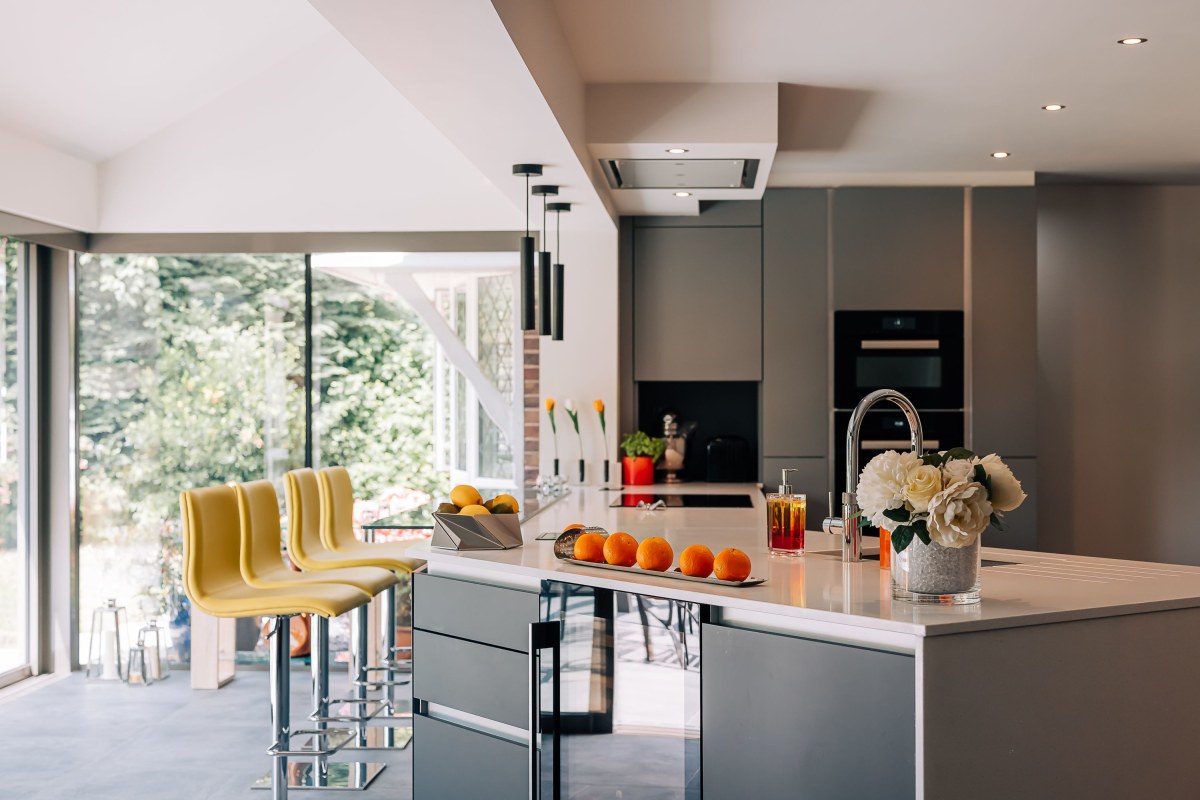 A kitchen with large window in the background