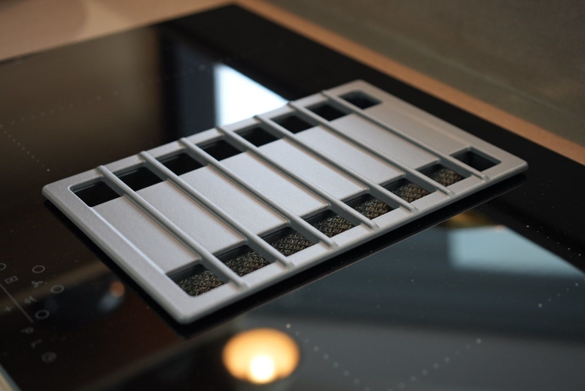 A black Venting Hob set into a black induction hob to remove smoke and cooking smells