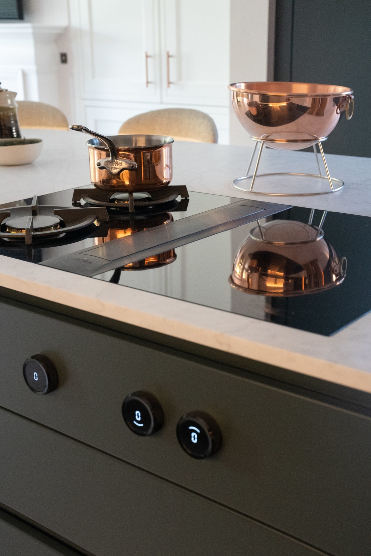 a bora venting hob with a pan on the left gas ring and a copper bowl in the background