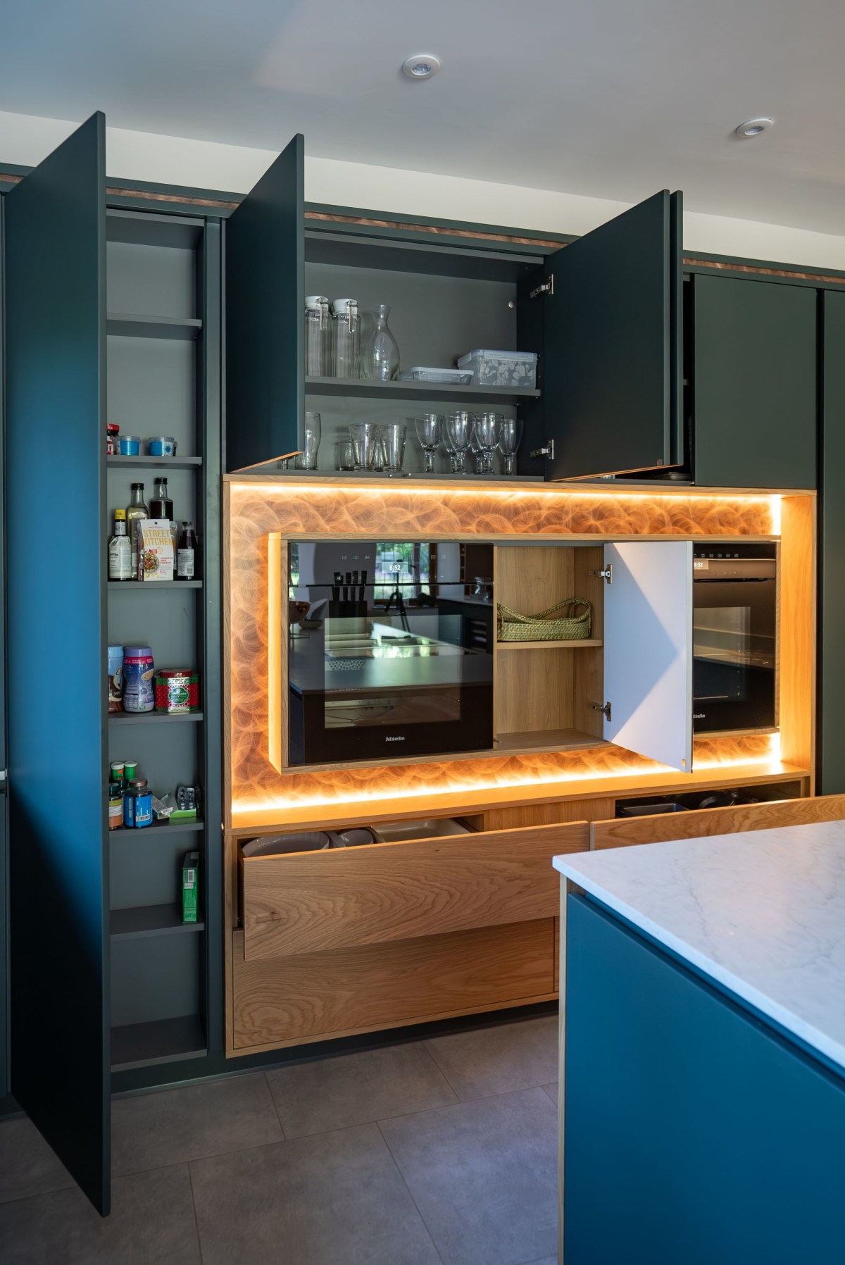 open cupboards around an illuminated feature oven set