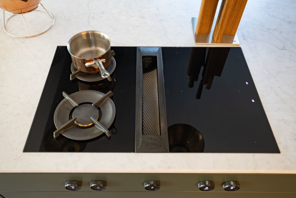 a bora venting induction hob in black with a pan on the top left